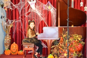 A young Ashley Dixon performs at the Little Chopin Halloween recital